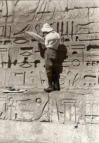 A tourist studying Egyptian hieroglyphs